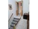 Image shows a carpeted staircase with wood railing at 2631 Fiesta Dr, Venice, FL 34293