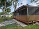 Screened porch with wooden deck and lattice at 2631 Fiesta Dr, Venice, FL 34293