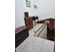 View of upper landing with wood storage and a staircase leading down at 2631 Fiesta Dr, Venice, FL 34293