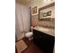 Bathroom with granite countertop and dark wood vanity at 2631 Fiesta Dr, Venice, FL 34293