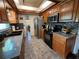 Spacious kitchen with dark wood cabinets and granite countertops at 2631 Fiesta Dr, Venice, FL 34293