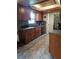 Kitchen features dark wood cabinets, granite countertops, and tile floors at 2631 Fiesta Dr, Venice, FL 34293