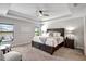 Large main bedroom with plush carpet, a king-size bed, and ceiling fan at 16162 61St E Ln, Parrish, FL 34219