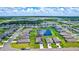 Aerial view of a house and surrounding neighborhood with a pond at 16162 61St E Ln, Parrish, FL 34219