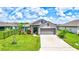 Single-Gathering home with gray exterior and two-car garage at 16162 61St E Ln, Parrish, FL 34219