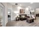 Comfortable living room with leather seating and access to other rooms at 16162 61St E Ln, Parrish, FL 34219