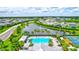 Aerial view showing a community pool, lake, and homes at 16162 61St E Ln, Parrish, FL 34219