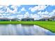 Home overlooks a serene pond with lush landscaping at 16162 61St E Ln, Parrish, FL 34219