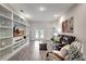 Living room with built-in shelving and French doors leading to backyard at 16162 61St E Ln, Parrish, FL 34219