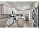 Modern kitchen with white cabinets, granite counters, and stainless steel appliances at 16162 61St E Ln, Parrish, FL 34219