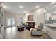 Open living room with tile floors, leather sofa, and built-in shelving at 16162 61St E Ln, Parrish, FL 34219