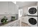 Bright laundry room with modern washer, dryer, and ample cabinetry at 16162 61St E Ln, Parrish, FL 34219