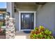 Modern black front door with stone accents and landscaping at 16162 61St E Ln, Parrish, FL 34219
