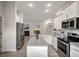 Modern kitchen with white cabinets, granite island, and stainless steel appliances at 16162 61St E Ln, Parrish, FL 34219
