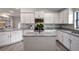 Modern kitchen with white cabinets, granite island, and stainless steel appliances at 16162 61St E Ln, Parrish, FL 34219
