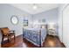 Cozy bedroom with metal bed frame and hardwood floors at 15016 Bowfin Ter, Lakewood Ranch, FL 34202