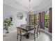 Elegant dining room with chandelier, large windows, and seating for six at 15016 Bowfin Ter, Lakewood Ranch, FL 34202