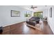 Relaxing living room featuring a leather couch and hardwood floors at 15016 Bowfin Ter, Lakewood Ranch, FL 34202