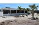 Exterior view of clubhouse featuring big windows, palm trees, and well-maintained landscaping at 4939 Lakescene Pl, Sarasota, FL 34243