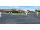 Entrance to a golf clubhouse with a circular driveway and well-manicured grounds at 4939 Lakescene Pl, Sarasota, FL 34243