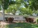 An Avalon at The Villages of Palm-Aire sign nestled among vibrant landscaping at 4939 Lakescene Pl, Sarasota, FL 34243