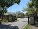 An inviting gated entrance with meticulously maintained landscaping and serene street view at 4939 Lakescene Pl, Sarasota, FL 34243
