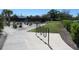 Walking path to the community tennis courts with greenery and bike rack for outdoor activities at 4939 Lakescene Pl, Sarasota, FL 34243