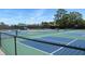Well-maintained tennis and pickleball courts under a bright, sunny sky at 4939 Lakescene Pl, Sarasota, FL 34243