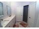 Modern bathroom featuring double sinks, a shower, marble floors, and stylish blue and white tile accents at 5107 Whispering Oaks Dr, North Port, FL 34287