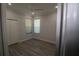 A serene bedroom with light gray walls, light-colored floors, a ceiling fan, and a double-door closet at 5107 Whispering Oaks Dr, North Port, FL 34287