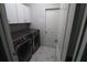 Bright laundry room with washer, dryer, and extra cabinets at 5107 Whispering Oaks Dr, North Port, FL 34287
