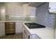 Modern kitchen with white cabinets, a gas cooktop and quartz countertops at 5107 Whispering Oaks Dr, North Port, FL 34287
