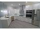 Modern kitchen with white cabinets, stainless steel appliances, and quartz countertops at 5107 Whispering Oaks Dr, North Port, FL 34287