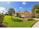 House exterior with a two-car garage and lush landscaping at 5107 Whispering Oaks Dr, North Port, FL 34287