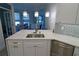 Modern kitchen island with a stainless steel sink and quartz countertop at 5107 Whispering Oaks Dr, North Port, FL 34287