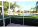 Peaceful screened patio overlooking a pond and lush landscape at 5107 Whispering Oaks Dr, North Port, FL 34287