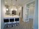 Modern kitchen with island seating, white cabinets and stainless steel appliances at 5107 Whispering Oaks Dr, North Port, FL 34287