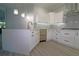 Modern kitchen with white cabinets, a large island, and quartz countertops at 5107 Whispering Oaks Dr, North Port, FL 34287