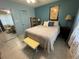 Cozy bedroom with a comfortable bed and light blue walls at 5850 Welcome Rd # J6, Bradenton, FL 34207