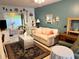 Living room features a light beige couch, green recliner, and decorative accents at 5850 Welcome Rd # J6, Bradenton, FL 34207