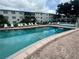 Community pool with plenty of lounge chairs for sunbathing at 5850 Welcome Rd # J6, Bradenton, FL 34207