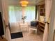 Bright sunroom with a comfortable chair, small table, and built-in shelving at 5850 Welcome Rd # J6, Bradenton, FL 34207