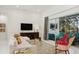 Open living space featuring a sectional sofa, sliding glass doors to patio, and a large TV at 3973 Boca Pointe Dr, Sarasota, FL 34238