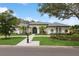 Large home with a circular driveway and lush landscaping at 3973 Boca Pointe Dr, Sarasota, FL 34238