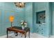 Light and bright office with built-ins and a beautiful chandelier at 3973 Boca Pointe Dr, Sarasota, FL 34238