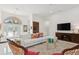 Bright living room with comfy sectional sofa, stylish coffee table, and large TV at 3973 Boca Pointe Dr, Sarasota, FL 34238