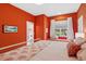Bedroom with coral walls, window seat, and ensuite bathroom at 3973 Boca Pointe Dr, Sarasota, FL 34238