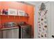 Laundry room with washer, dryer, and storage shelves at 3973 Boca Pointe Dr, Sarasota, FL 34238
