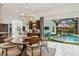 Breakfast nook with pool view and modern chandelier at 3973 Boca Pointe Dr, Sarasota, FL 34238