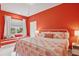 Bright bedroom with coral walls and window seat at 3973 Boca Pointe Dr, Sarasota, FL 34238